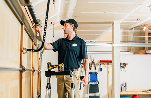 Technician Repairing Garage Door